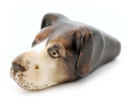 A Royal Worcester whistle modelled as the head of a dog with painted features, puce mark, circa 1920s, length 3.7cm