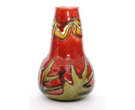 An early 20th Century Minton Secessionist vase No. 42 decorated with tubelined spiked leaves and a wavy pattern to the rim, a