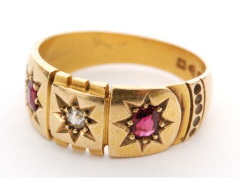 An early 20th Century 18ct hallmarked ruby and diamond three stone ring, central diamond flanked by rubies all stones gypsy s
