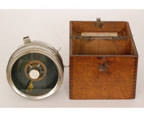 A chromium plated circular pigeon clock in oak case.