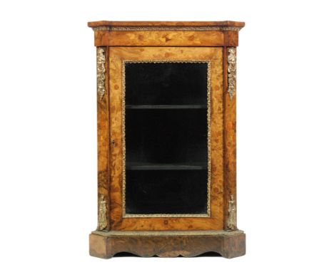 A late 19th Century French marquetry inlaid figured walnut pier cabinet, the shelf interior enclosed by a glazed door below a