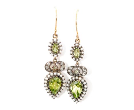 A pair of peridot, seed pearl and diamond pendant earrings, pear shaped peridot within a seed pearl surround below a similar 