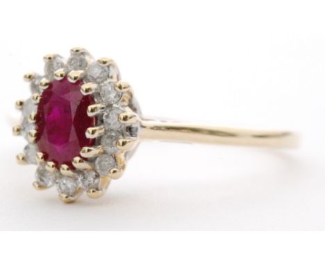 A 9ct ruby and diamond cluster ring, central oval ruby within a fourteen stone diamond surround, all stones claw set to knife