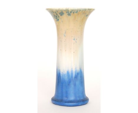 A Ruskin Pottery trumpet vase decorated in a mottled pale orange to blue with green crystalline flecks, impressed mark, dated