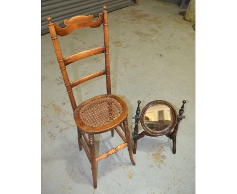 A late 19th Century childs beech ladder back correction chair on splayed legs with a cane seat, together with a small circula