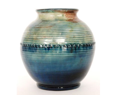 A large 1930s William Moorcroft 'Natural Pottery' footed ovoid lamp base decorated in a tonal green to blue with flambe spott