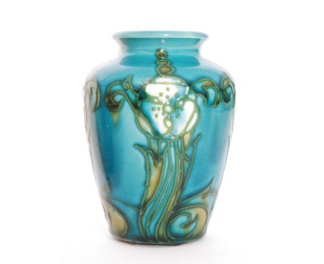 An early 20th Century Minton Secessionist vase No.7 decorated with tubelined flowers and foliage against a blue ground, print