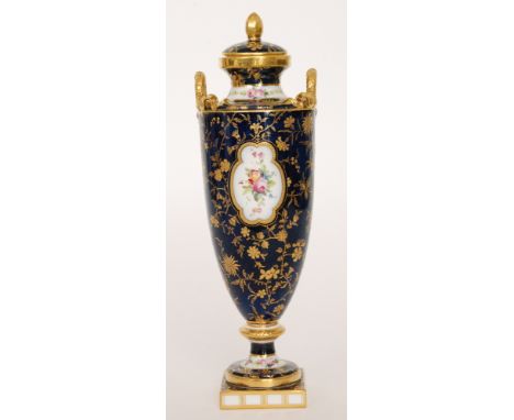 A late 19th to early 20th Century Minton pedestal vase and cover, the body decorated with two cartouche panels with hand pain