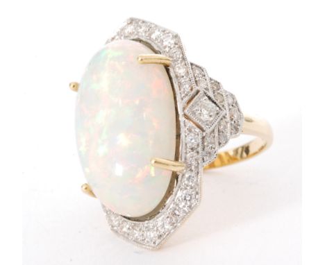 An 18ct opal and diamond ring in the Art Deco taste, claw set opal within a border of millegrain set diamonds, stepped diamon