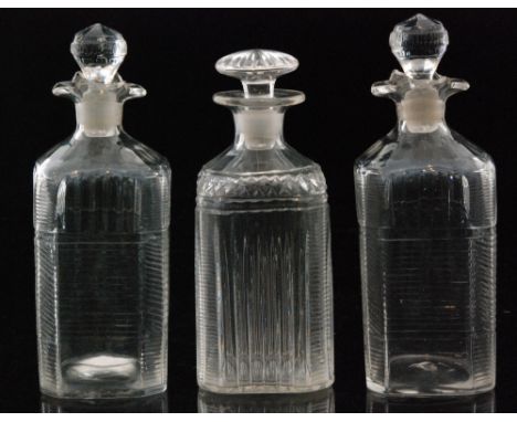 A pair of 19th Century glass spirit flasks of square sleeve form with canted corners, each decorated with mitre cutting, heig