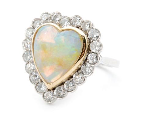 An 18ct white gold opal and diamond heart shaped ring, central heart shaped opal, collar set within a diamond surround to a p