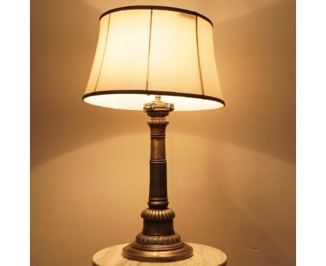 A sophisticated neoclassical-style table lamp featuring a fluted column base with an antique silver-tone finish and intricate