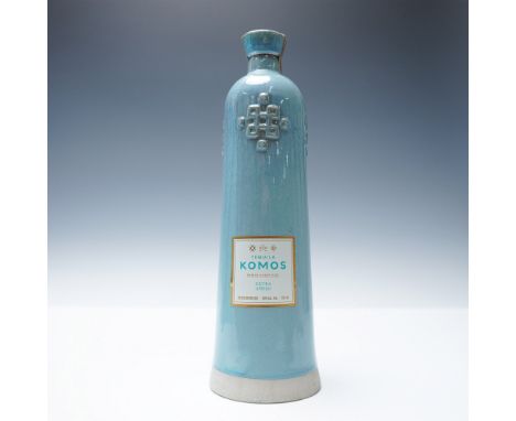 Tequila Komos Extra Anejo, presented in an artisanal blue ceramic bottle, is crafted from 100% Blue Weber Agave and aged for 