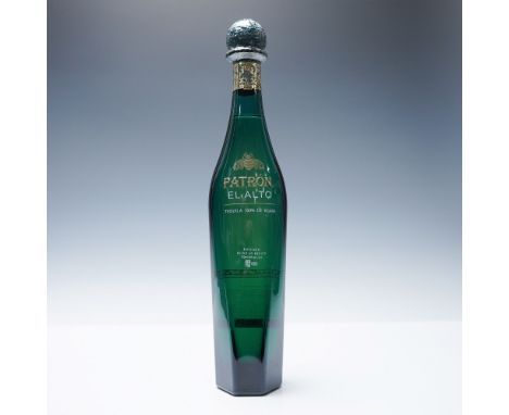 Patron El Alto Reposado Tequila, a premium 100% Blue Weber Agave spirit, is presented in an elegant green bottle with gold ac