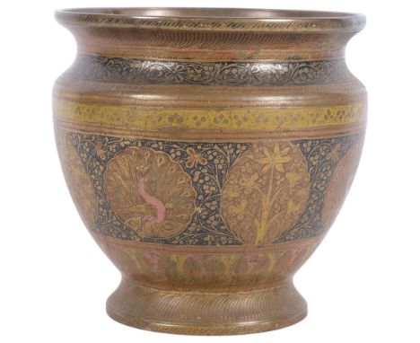 An ornate Anglo-Indian brass planter, with embossed floral and peacock decorative design, H17.5cm