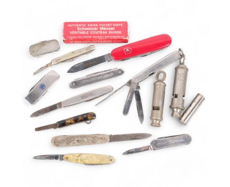 A collection of various penknives, including a Swiss Army example, a Metropolitan whistle, etc