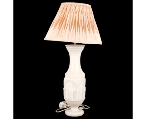 A relief carved alabaster table lamp, with Gothic figural carving to centre, with associated shade, overall height 80cm