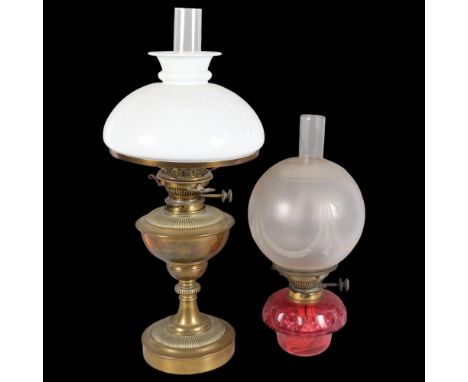 An Antique Victorian brass oil lamp and associated milk glass shade and funnel, H57cm, and a second cranberry glass oil lamp 