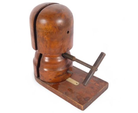 An early 20th century hat stretcher on rectangular stand, with plastic scale, H33cm
