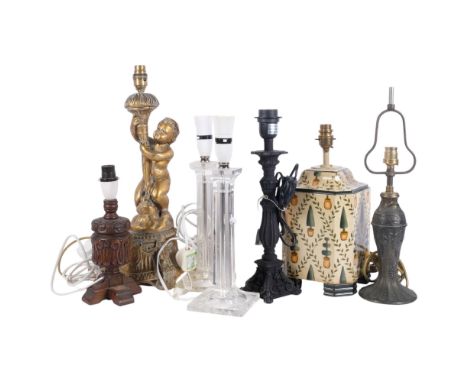 A pair of clear plastic table lamps, a gilded plaster lamp with cherub support, 47cm overall, a ceramic lamp decorated with t