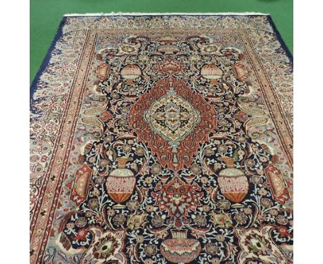 A Persian style carpet, with all over floral designs on a blue ground, 390 x 290cm