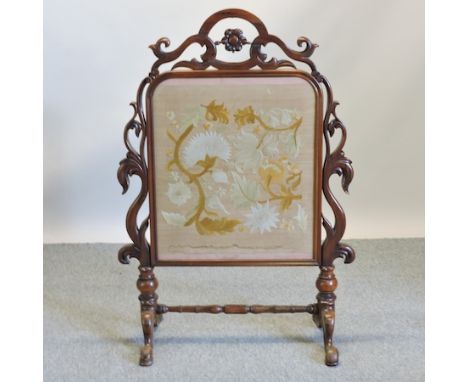 A Victorian rosewood fire screen, with a floral insert, 127cm high