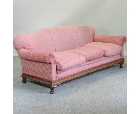 A 1920's pink upholstered three seater sofa, on squat cabriole legs, 198cm