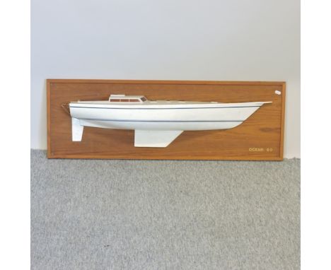 A half hull model of a boat, mounted on a wooden plaque, 107cm