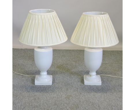 A pair of white ceramic table lamps together with shades, 70cm high