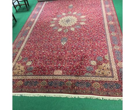 A large Wilton carpet, with red floral designs, 465 x 275cm