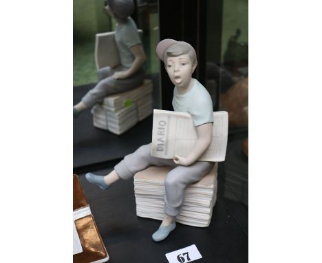 Nao figure of a Paper boy on a stack of papers 