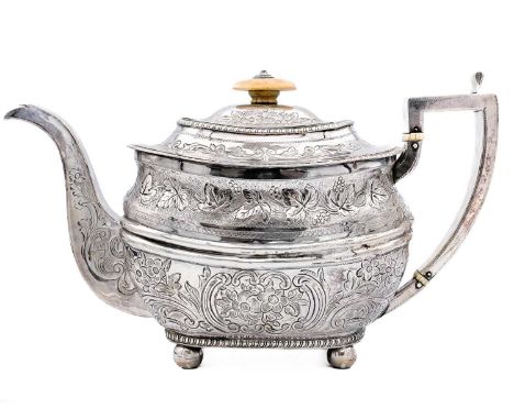 A George III silver teapot by Duncan Urquhart & Naphtali Hart. With foliate scroll and fruiting vine embossed decoration and 