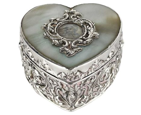 A Victorian silver and mother-of-pearl heart-shaped trinket box. The hinged lid with mother-of-pearl inset and with small cir