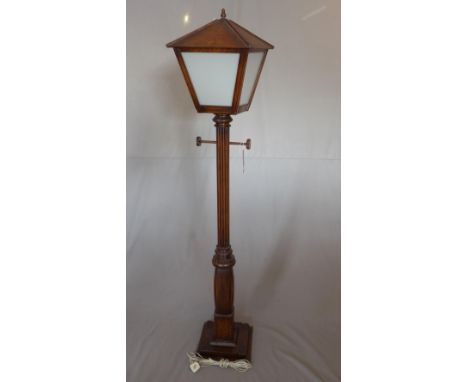 A 1940's carved oak standard lamp, in the form of a street lamp, H.182cm