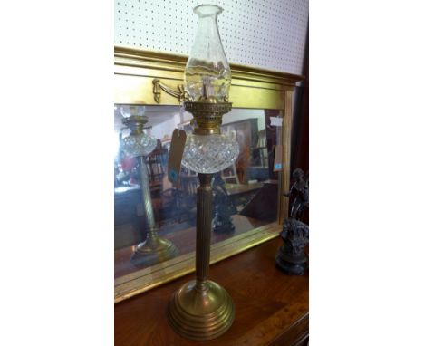 A late 19th century brass oil lamp, with crystal glass bowl, raised on reeded column and stepped base, H.75cm 