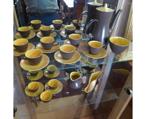 A Poole pottery tea set, comprising of teapot, 9 cups, 8 saucers, milk jug and sugar bowl, in brown and yellow glaze 