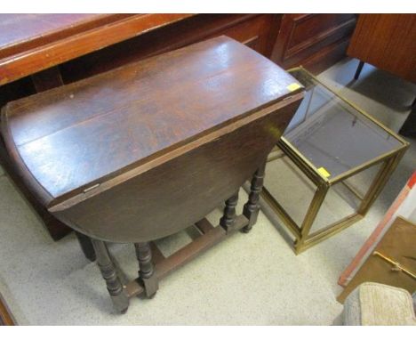 An early 20th century oak gate leg table, together with a nest of brass and glass topped tables 