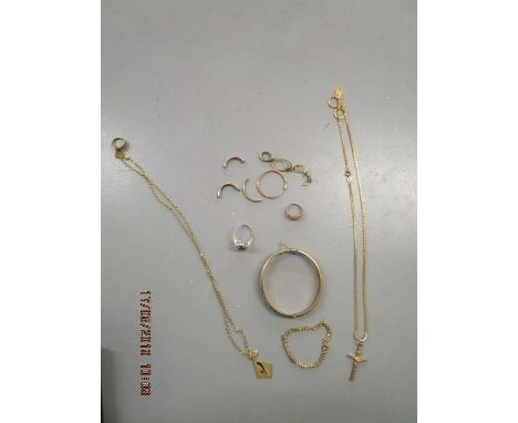 A quantity of 9 and 18ct gold jewellery to include a 9ct gold bangle 10.7g, an 18ct gold necklace with a St Christopher penda