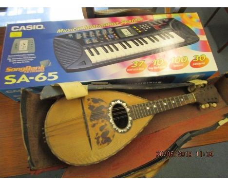 A cased Piltro Tonelli, Naples mandolin, along with a boxed Casio musical information system 