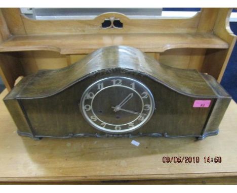 A walnut cased mantle clock with Arabic numerals and Westminster chimes 