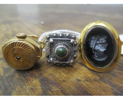 Three rings to include a silver example with a hinged lid, a Louis Philippe watch ring and a cameo style ring 