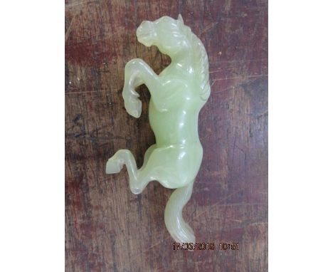 A Chinese carved green jade model of a rearing horse A/F 