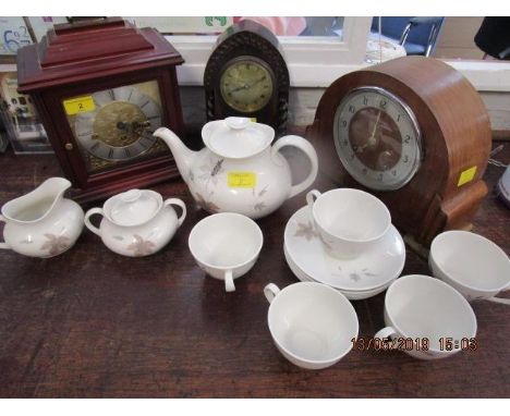 Three clocks to include a 1930s oak cased mantle clock, a walnut cased clock and a modern mahogany cased clock, along with a 