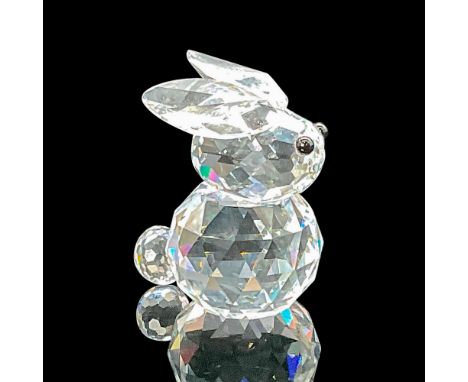 This rare bunny in faceted clear crystal features jet black eyes. This variation has ears that do not lie flat on the top of 