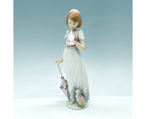 The glossy porcelain figurine depicts a lovely girl strolling with a white bird perched on her hand. This item has its origin