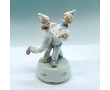 Cute figurine of two young clowns dancing on top of a rotating platform. Glossy finish; Meico sticker on the bottom. Dimensio