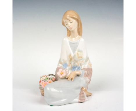 Young woman seated next to a basket of flowers. Lladro backstamp. This item has its original box which measures: 10"L x 9"W x