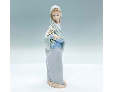 A glossy figure of a woman in a blue shawl embracing a bouquet of lilies. Lladro backstamp. Artist: Vincente MartinezIssued: 