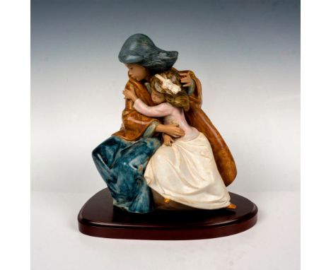 Depicts sisters in an embrace. Lladro backstamp. Gres finish. This item has a base included 10"L x 7.25"W x 1"H. This item ha