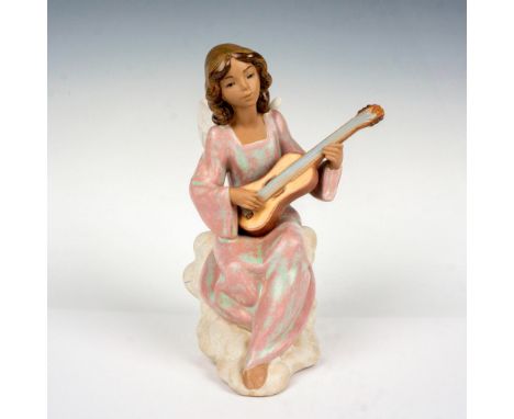 This gres finish porcelain figurine depicts an angel playing guitar. This item has its original box which measures: 10"L x 9"